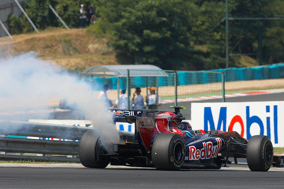 Jaime Alguersuari with smoke coming from his Toro Rosso-Ferrari car