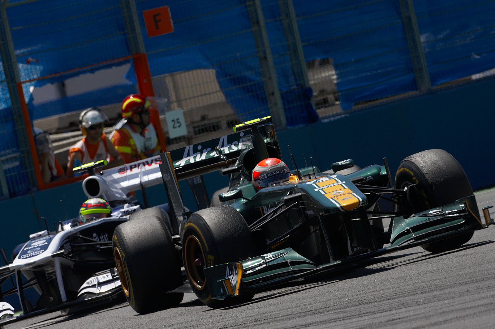Jarno Trulli, Team Lotus, in front of Maldonado