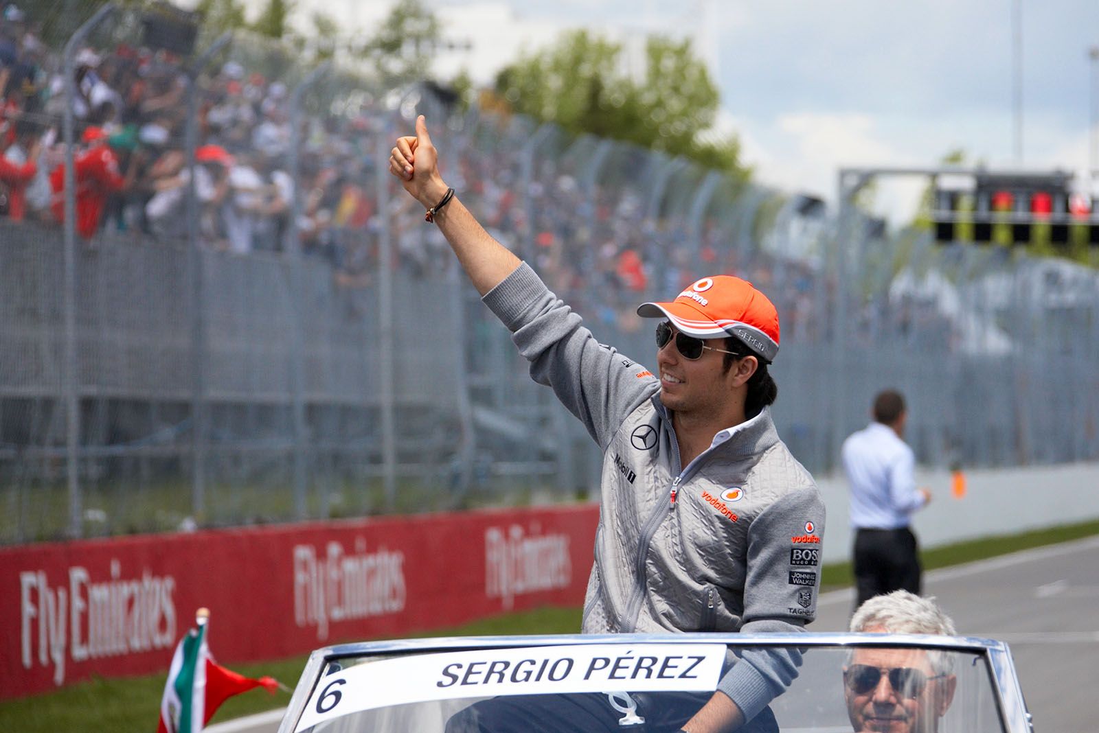 Sergio Perez of McLaren greets the cheering audience