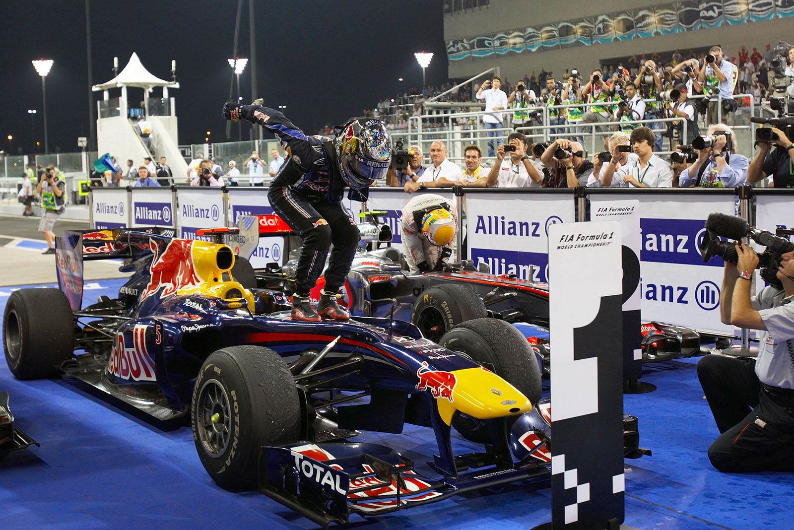 Race winner and new World Champion Sebastian Vettel jumps on his car in parc ferme