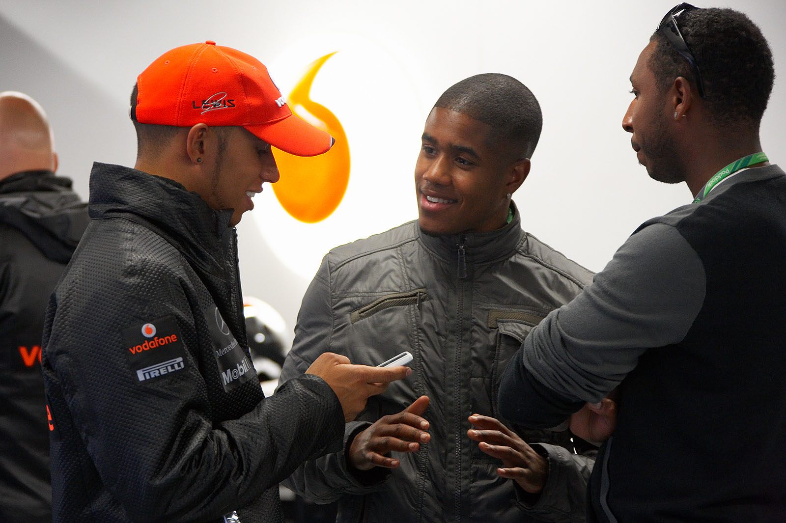 The retired 'Rambo' Hamilton chats with VIP guests in McLaren pits