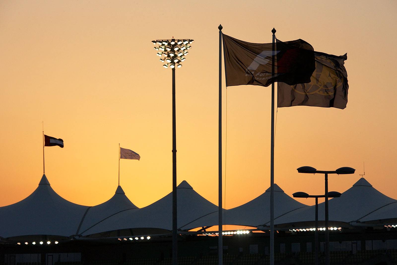 The sky burns above the stand roofs