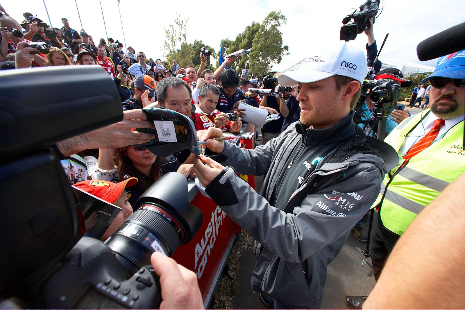 Mercedes racing driver Nico Rosberg gives autographs