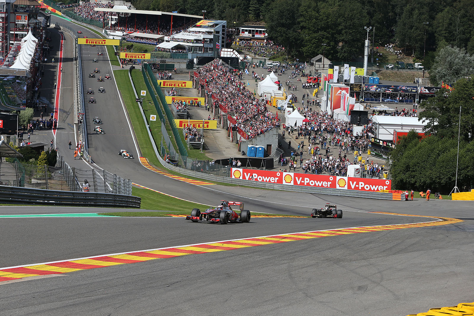 At the start of the Belgian Grand Prix 2012, the start field approaches Eau Rouge with pole setter Button in the lead followed by Raikkonen and a large gap to the other race cars because of the start accident