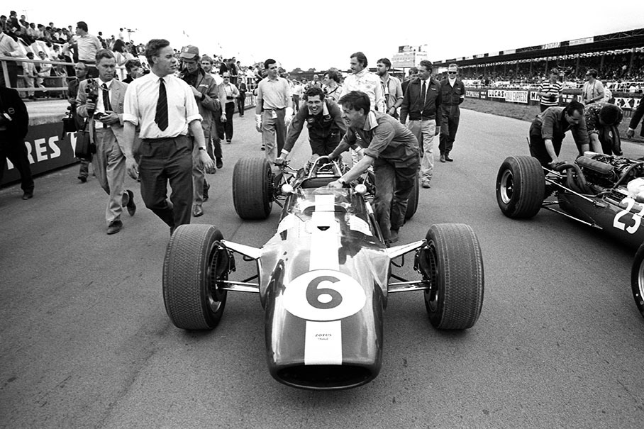 Graham Hill's repaired Lotus-Cosworth 49 is rolled on the grid for the British GP 1967