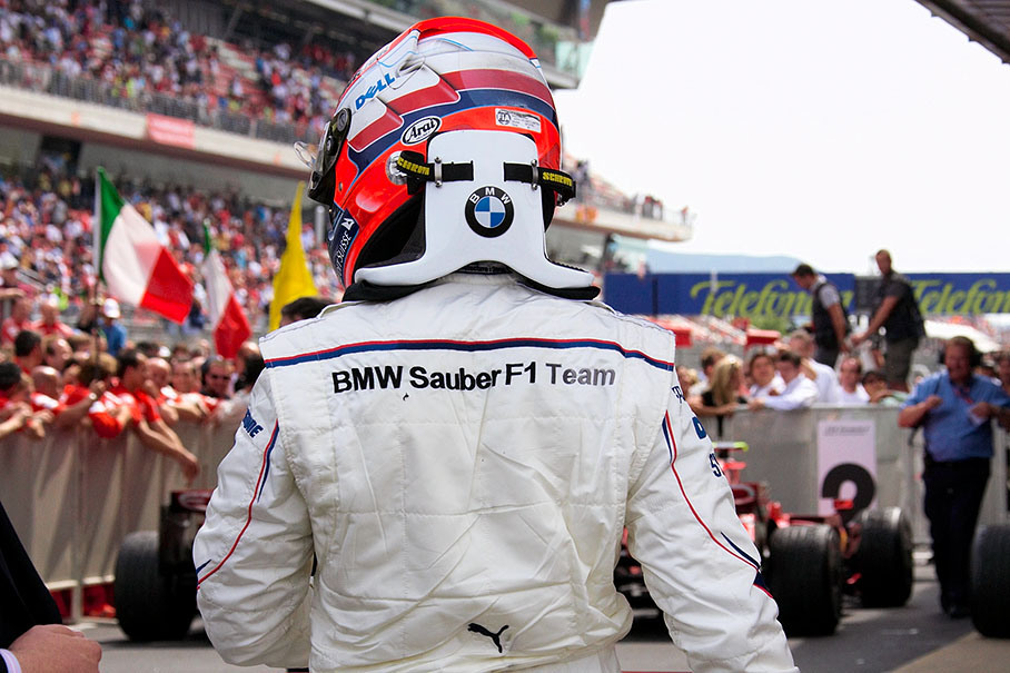 Fourth placed Robert Kubica walks towards parc ferme after the race