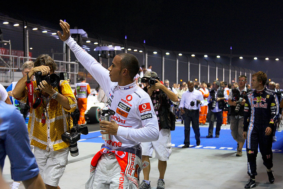Followed by photogreaphers, polesetter Hamilton and second qualified Vettel walk away from parc ferme after qualifying