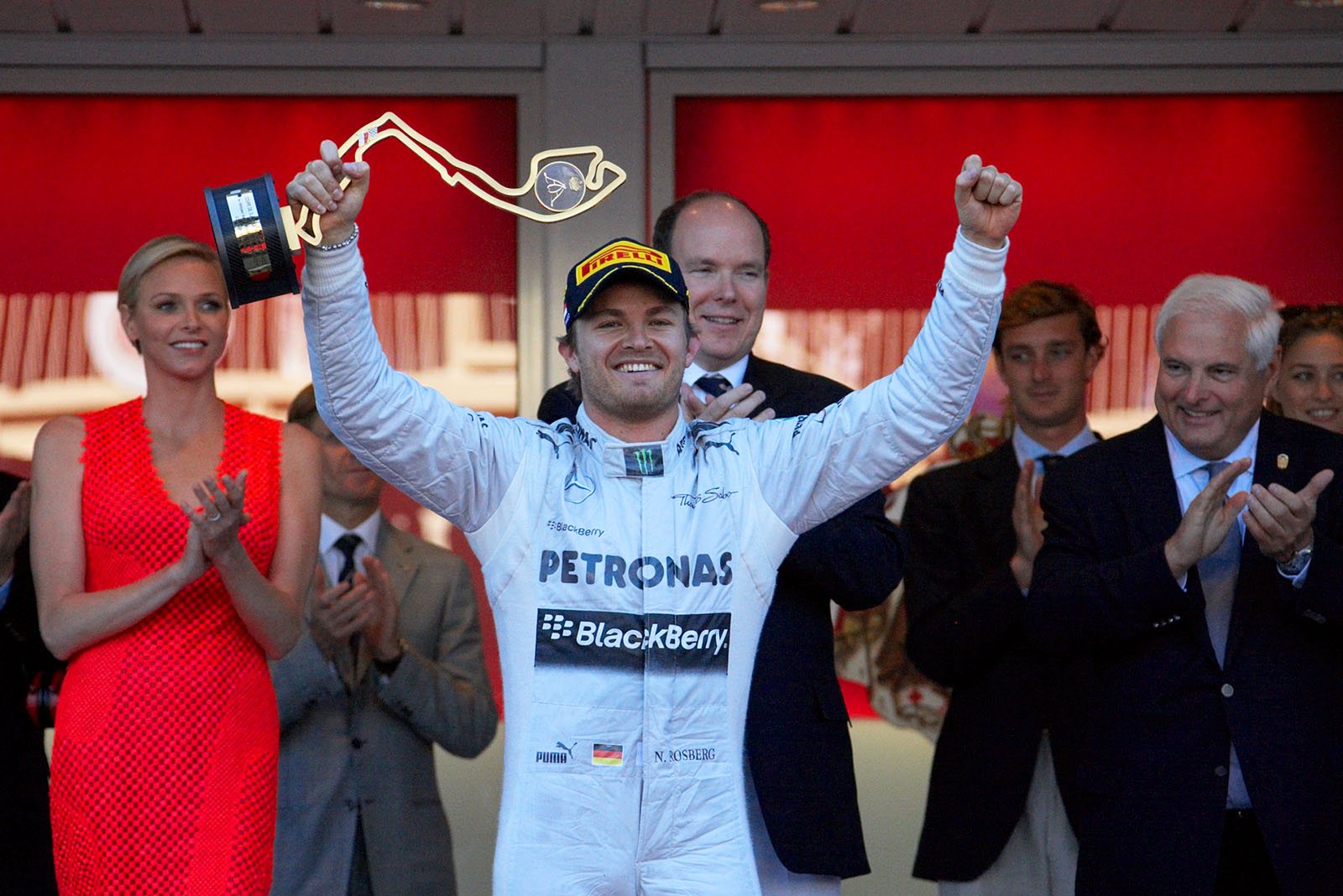 Local hero and race winner Nico Rosberg of Mercedes celebrates his achievement and raises his trophy on the podium