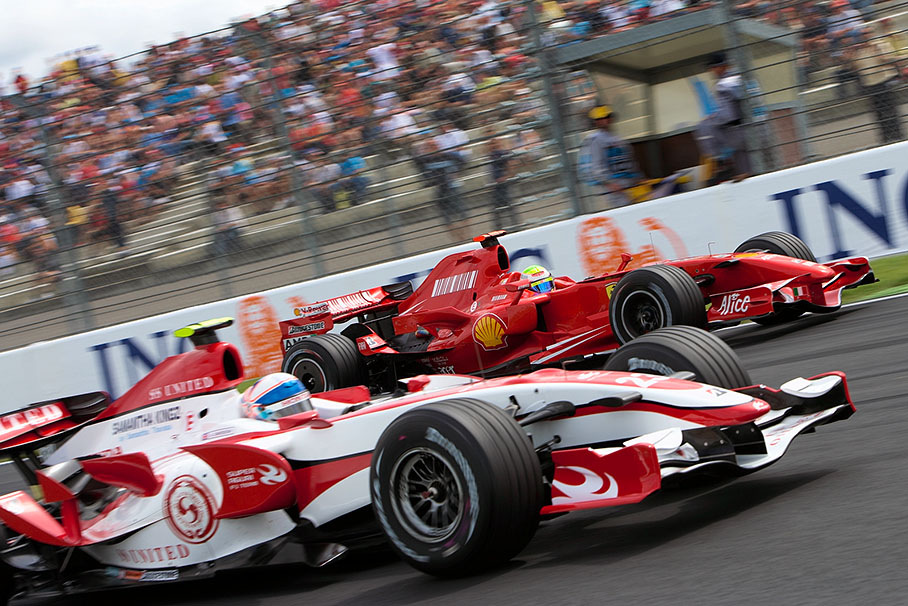 Ferrari driver Felipe Massa overtakes Super Aguri's Davidson on the outside at Adelaide hairpin