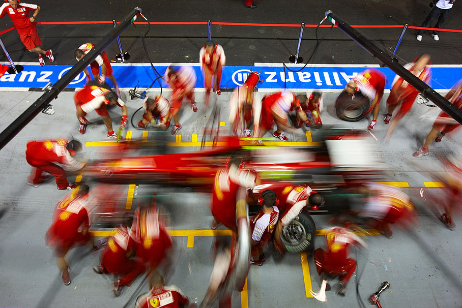 Ferrari mechanics practise pit stops on Thursday evening