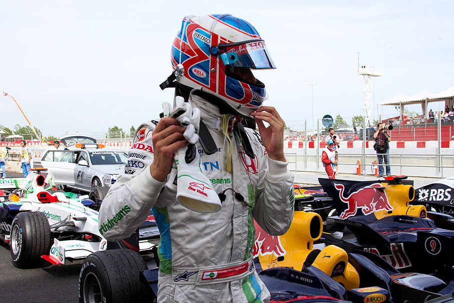 Jenson Button takes his helmet off after finishing sixth
