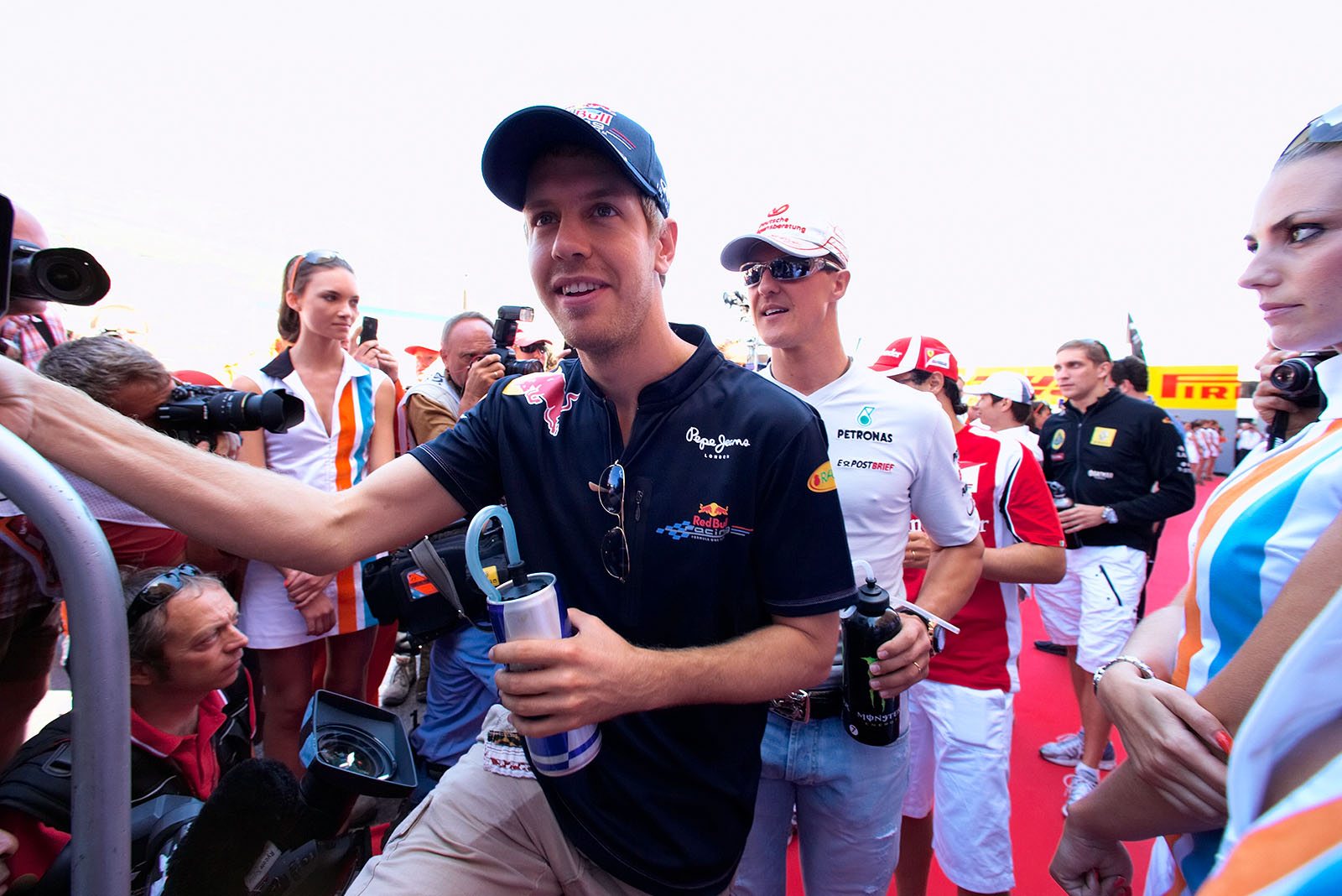 Sebastian Vettel climbs the drivers' parade truck.