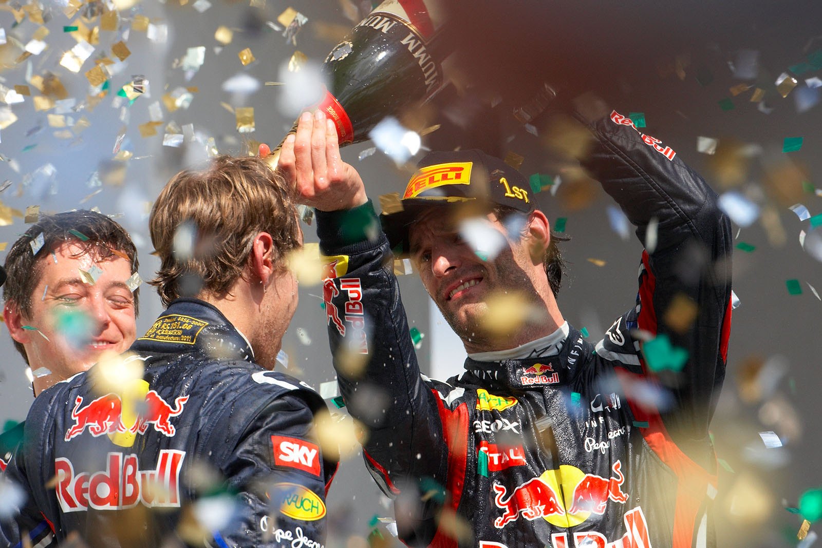 Champagne showers from Red Bull's race winner Mark Webber for his second placed team mate Sebastian Vettel on the podium after the Brazilian Grand Prix
