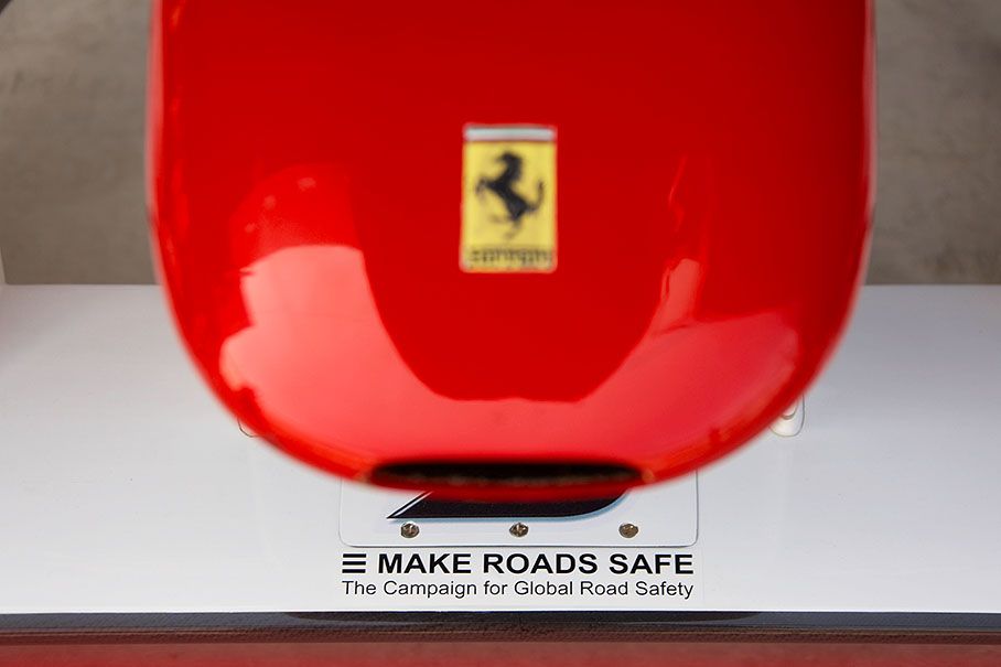 Make Roads Safe campaign sticker on a Ferrari car's front wing