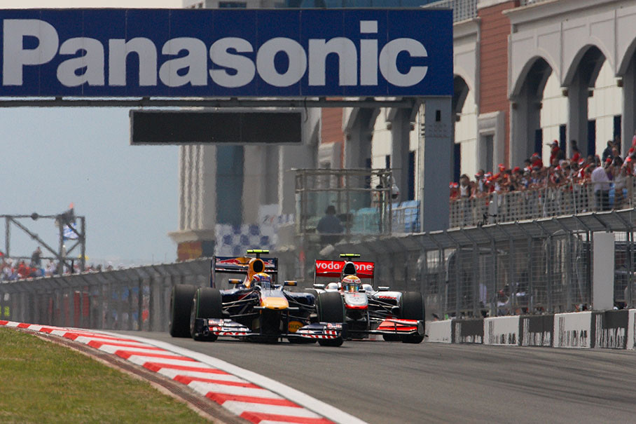 McLaren's Hamilton tries to overtake Mark Webber of Red Bull Racing