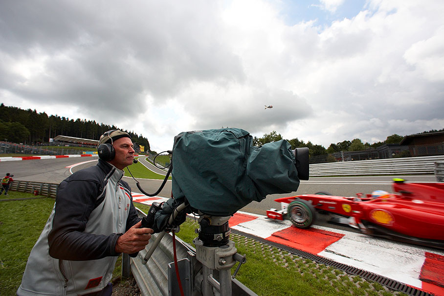 Alonso passes a TV camera at Eau Rouge
