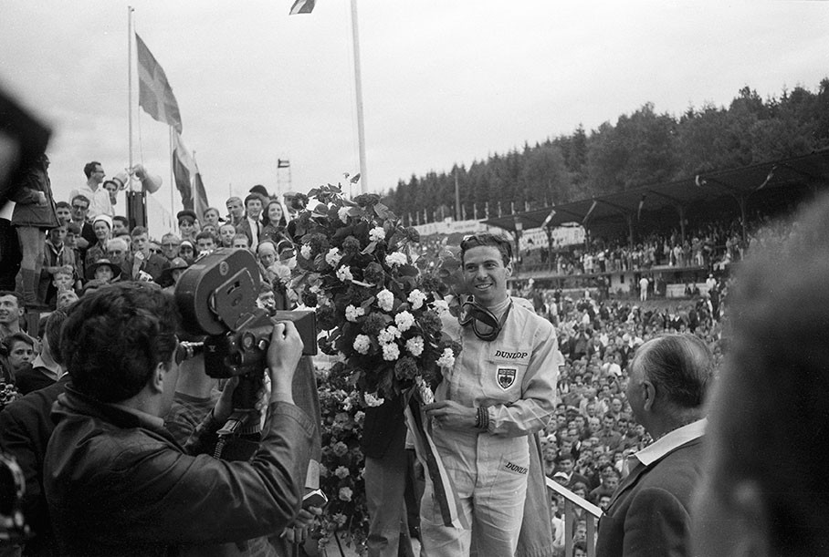 Jim Clark, winner of the Belgian GP 1964, celebrates on the podium after his successful race.