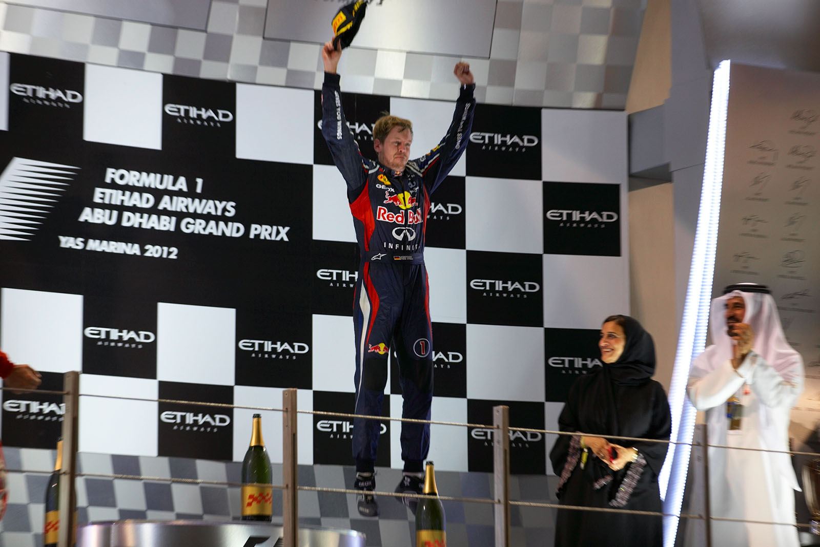Third placed Sebastian Vettel of Red Bull jumps to celebrate his great podium finish