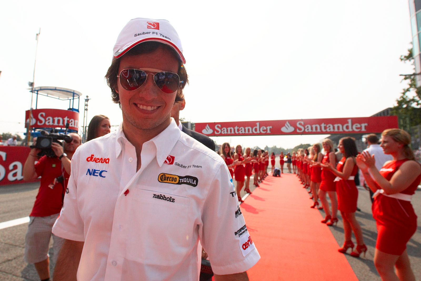 Sergio Perez enjoys the walkover to drivers parade through the cheering grid girls