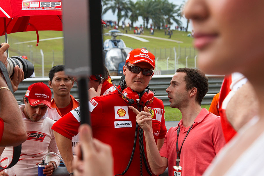 Massa's manager Nicolas Todt talks on the grid with Ferrari advisor Michael Schumacher