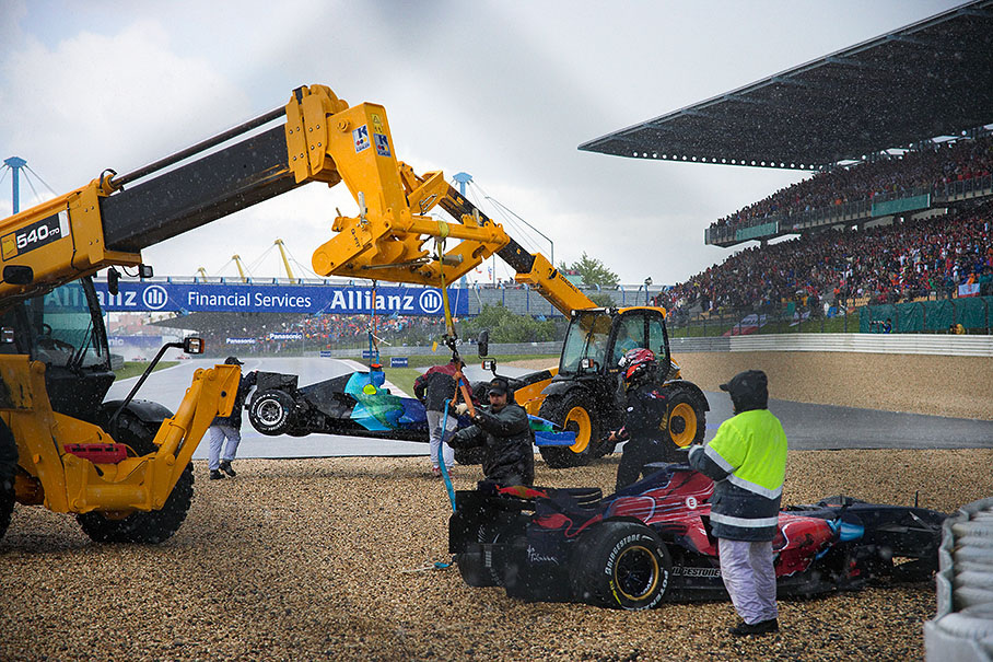 The retired cars of Button and Speed are being towed away