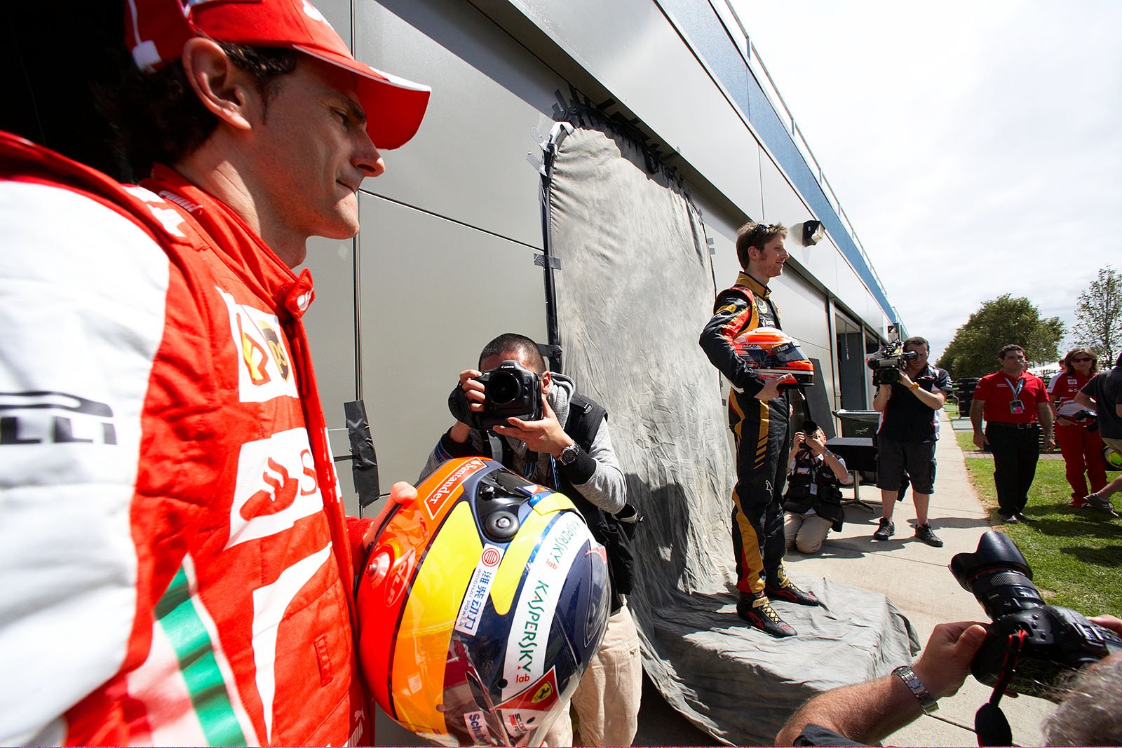Romain Grosjean, Lotus F1, poses for the media for the season opener photo shooting besides Ferrari development driver Pedro de la Rosa