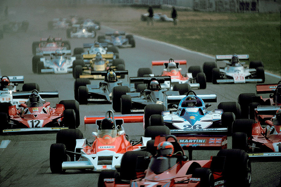 Start of the 1977 German Grand Prix at Hockenheim: The leader Scheckter (not on the picture) is followed by Watson's Brabham no. 7, James Hunt in the McLaren no. 1, Lauda (far right, Ferrari no. 11), Laffite (no. 26) and Reuteman in the 2nd Ferrari no. 12.