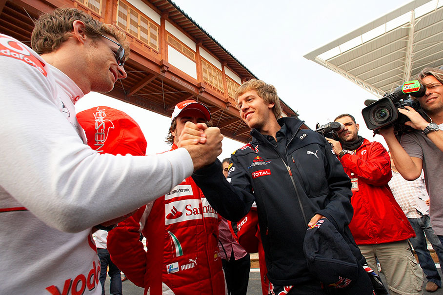 Handshake between Jenson Button and Sebastian Vettel before the group photo shooting