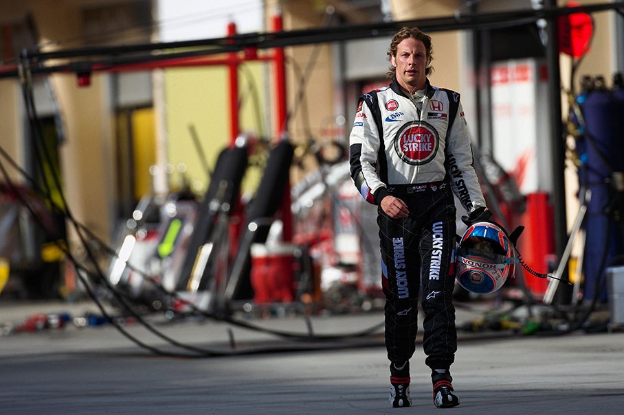 Jenson Button walks back through pitlane after retiring