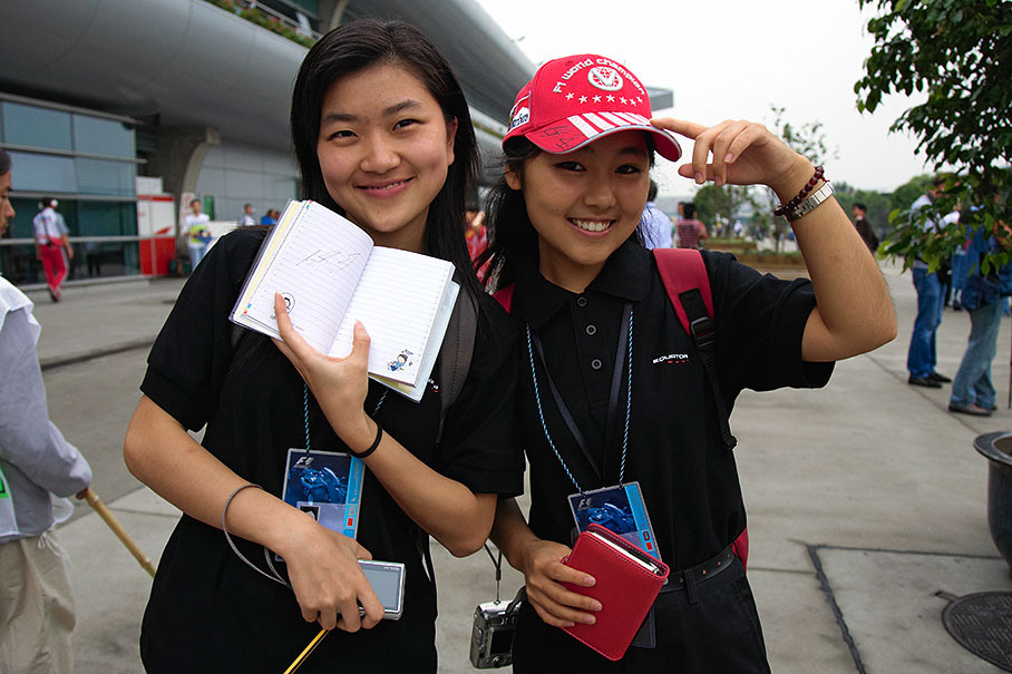Two Schumacher fans proudly presenting their just collected autograph