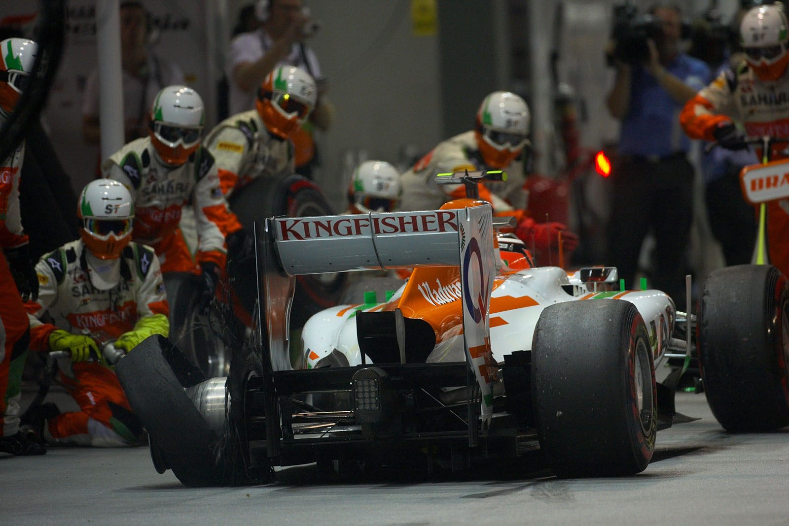 After his collision with Kobayashi, Nico Hulkenberg comes to Force India pits with a flat tyre