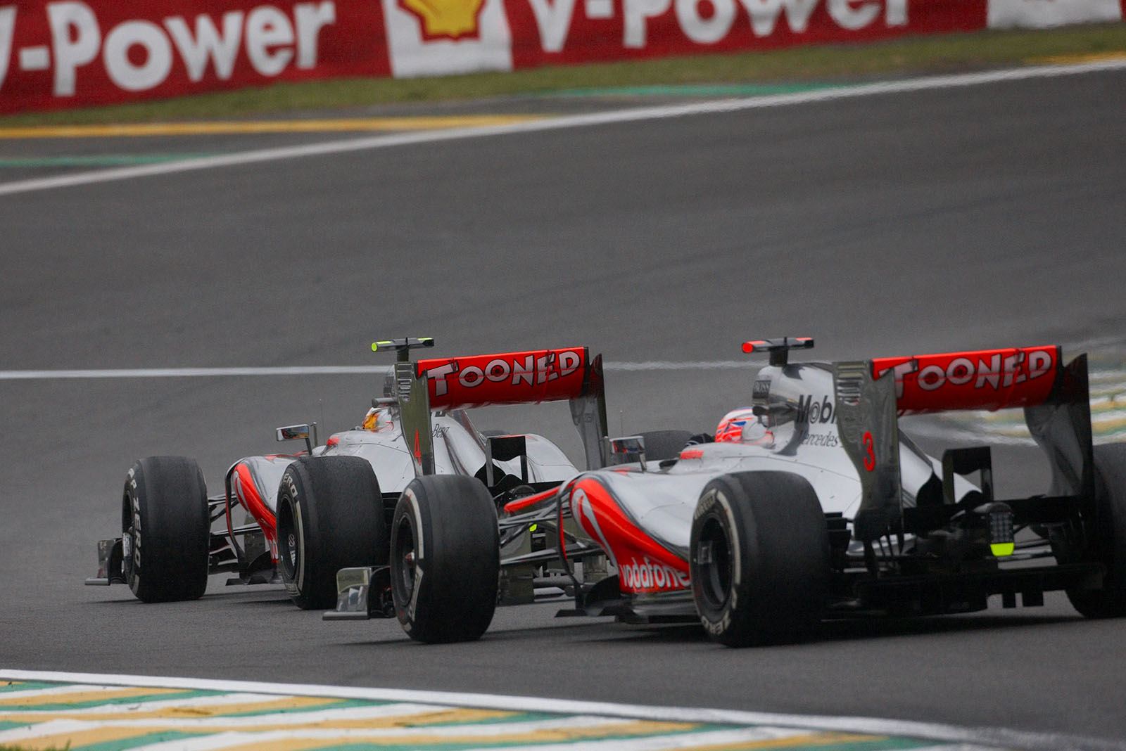 The two McLaren race drivers chase each other, Hamilton in front
