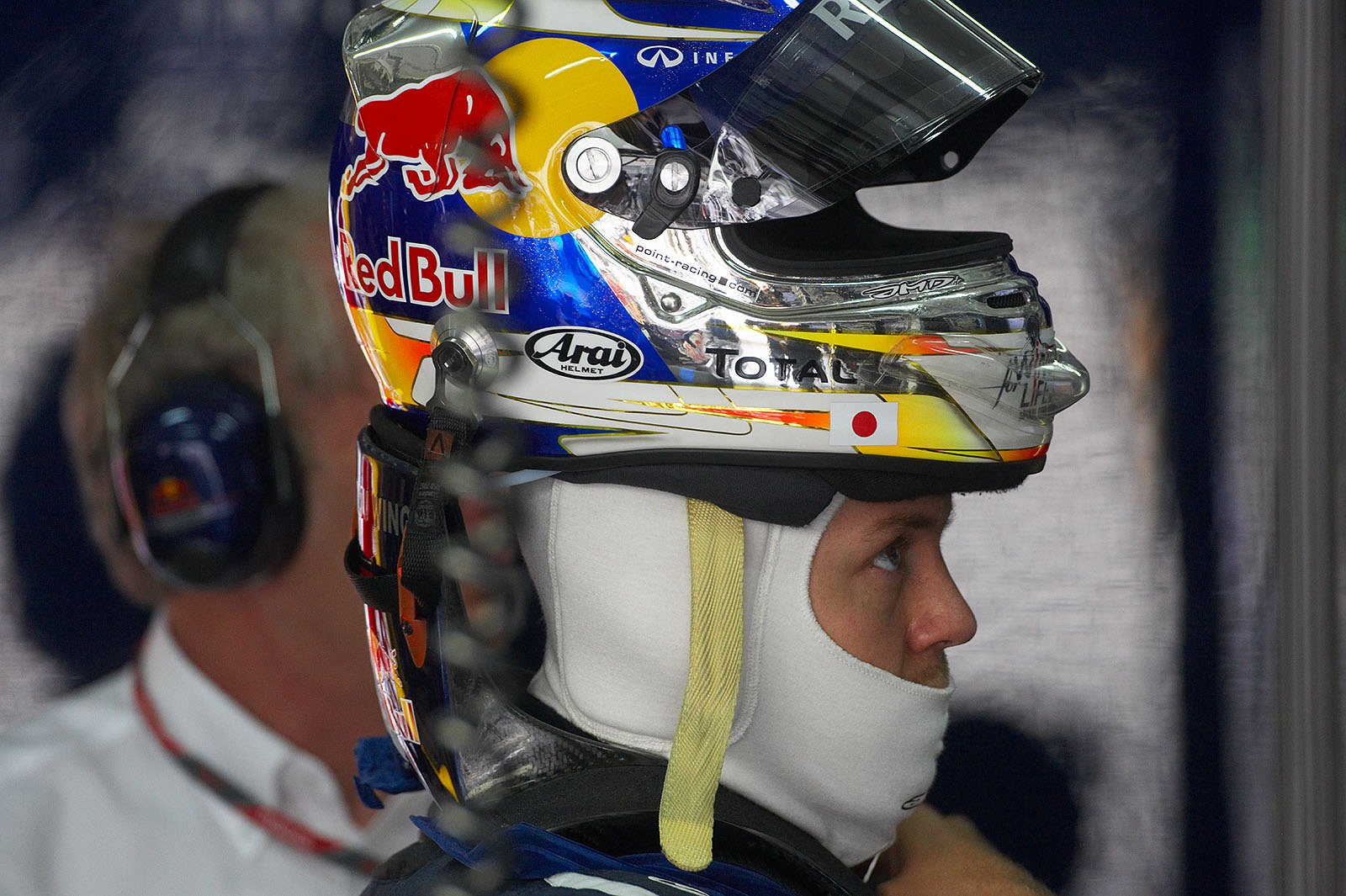 Sebastian Vettel puts his helmet on in Red Bull pits