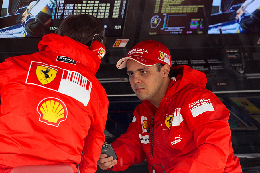 Felipe Massa speaks with race engineer Rob Smedley at Ferrari's pitwall command centre during a practice session