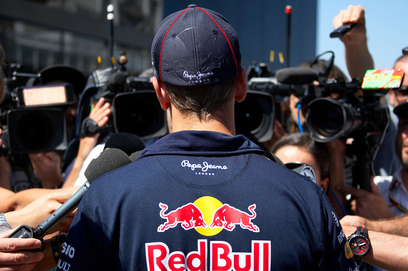 Sebastian Vettel surrounded by the press