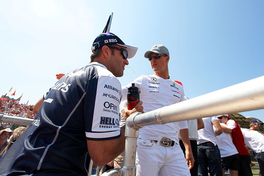 The old friends Barrichello and Schumacher arrive on the drivers parade truck