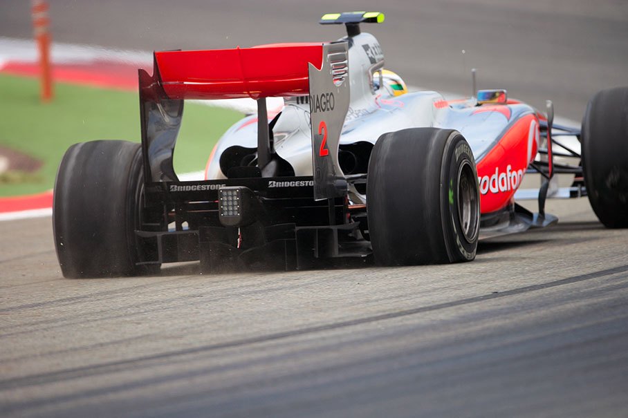 Lewis Hamilton in a slow McLaren Mercedes after a spin in turn 8, scratching the wooden board under his bottom and out of the line with two flat rear tyres