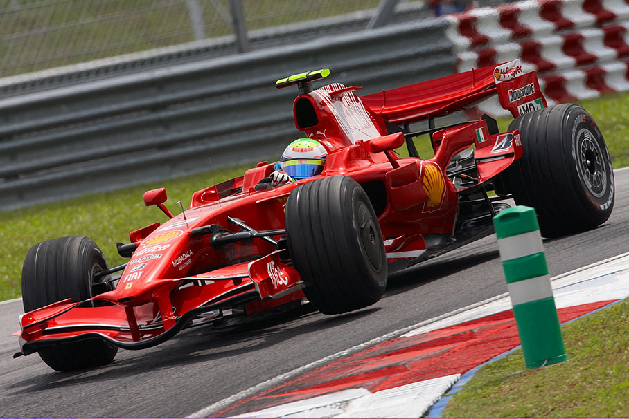 Felipe Massa lifts a wheel of his Ferrari