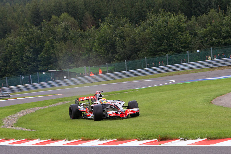 Lewis Hamilton takes a shortcut over the lawn at Les Combes