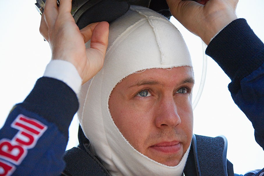 Polesitter Sebastian Vettel puts his helmet on before the race