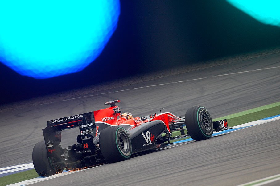 Sparks under Timo Glock's Virgin-Cosworth