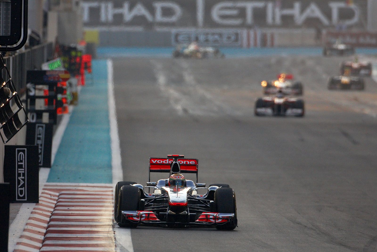Lewis Hamilton of McLaren Mercedes passes the pit boards in front of the followers
