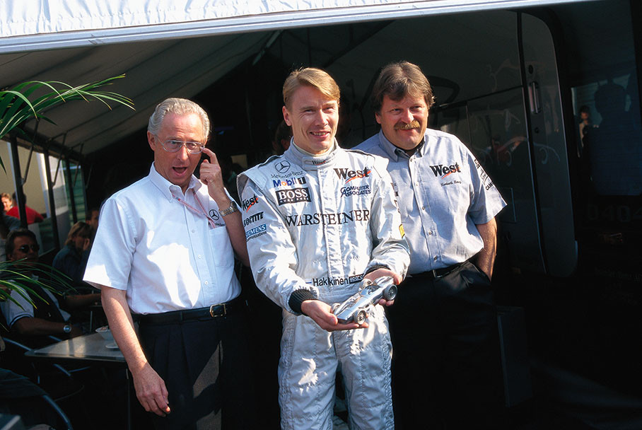 Left to right: Juergen Hubbert board director of Mercedes, McLaren-Mercedes driver Mika Hakkinen and Norbert Haug, head of Mercedes Motorsport.