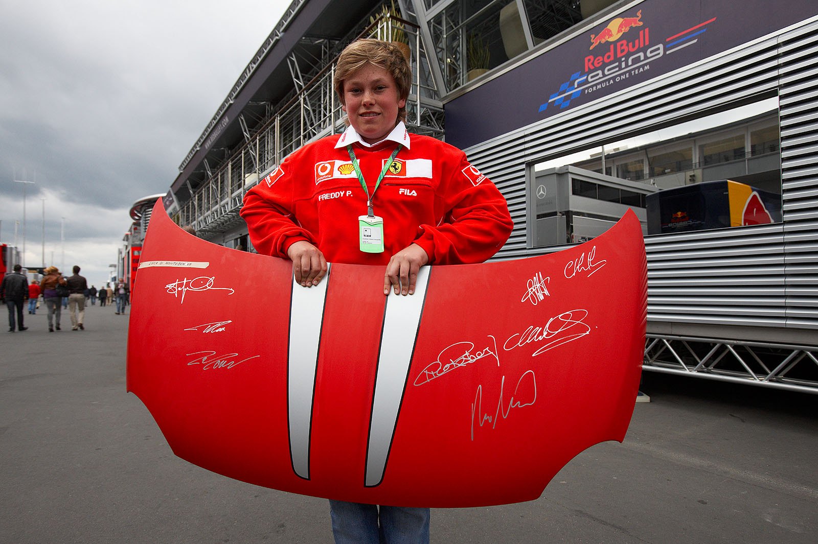 A young Ferrari fan shows his signed treasure