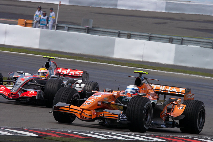Winkelhock, still on 'heavy rain tyres' is being overtaken by Hamilton who was first to change to dry condition tyres