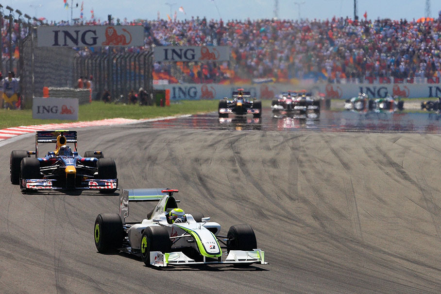 Brawn GP's Jenson Button manages to overtake polesetter Vettel during the first lap
