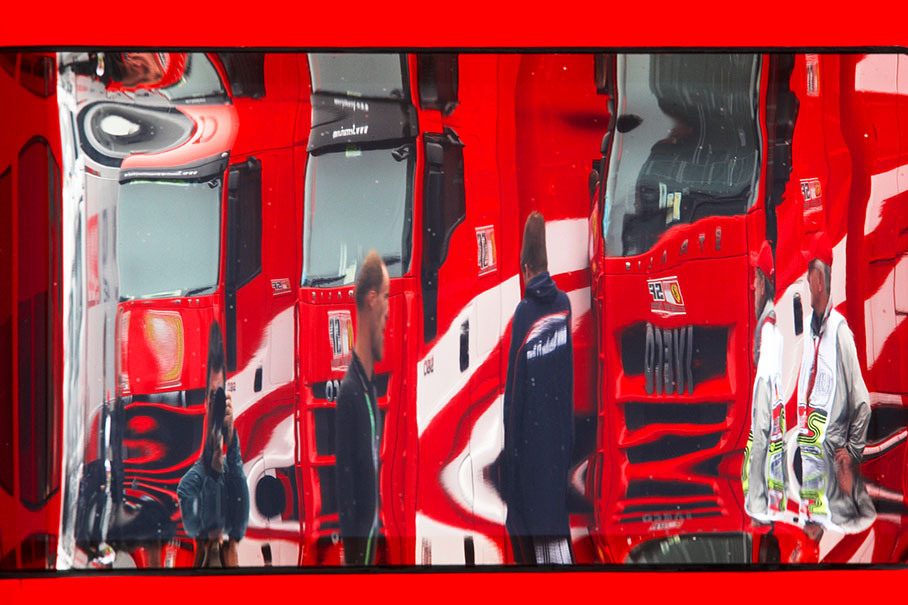 Ferrari trucks are being reflected in the motorhome windows