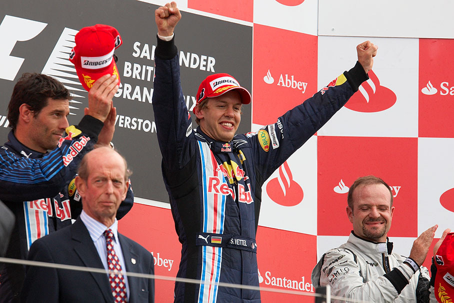 Race winner Sebastian Vettel and his second placed team mate Mark Webber (on his left) with third placed Rubens Barrichello and the Duke of Kent on Silverstone's podium