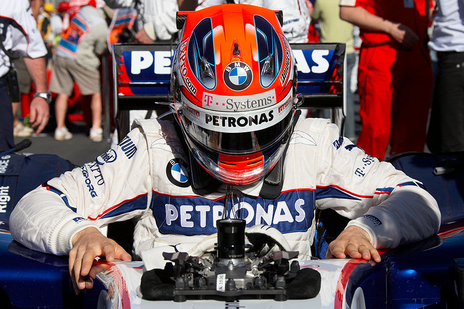 Having arrived at his fourth grid position, Robert Kubica climbs out of the BMW Sauber car