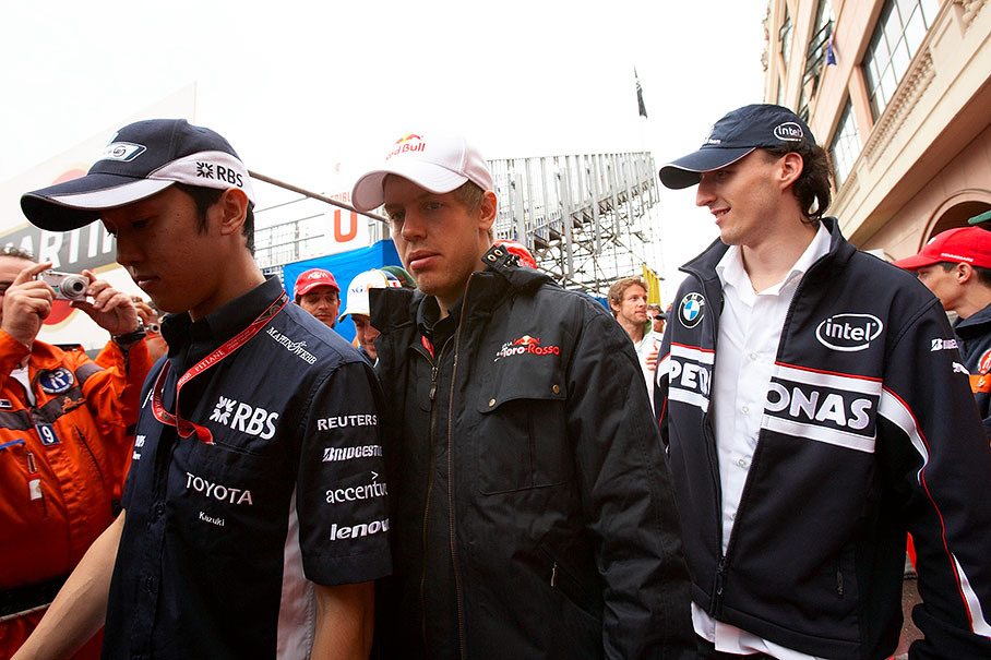 Sebastian Vettel walks to drivers parade between Kazuki Nakajima (left hand) and Robert Kubica